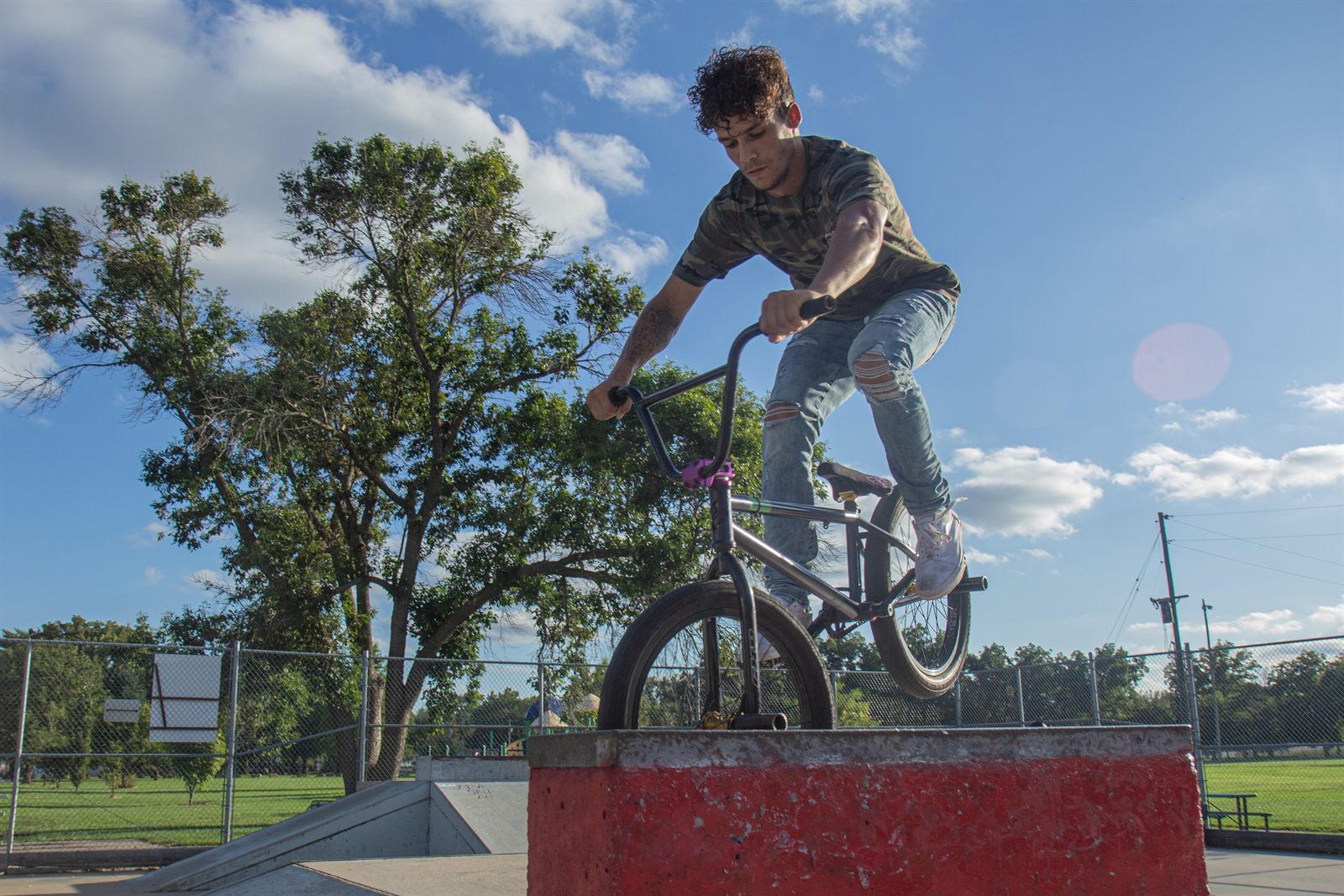 A rider on a BMX bike at the skatepark